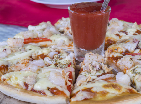 Pizza with seafood on tableの写真素材