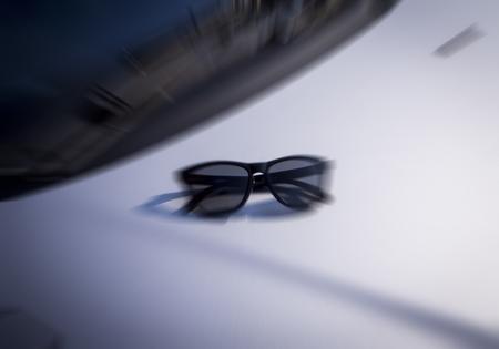 Black sunglasses on car , blur picture styleの写真素材