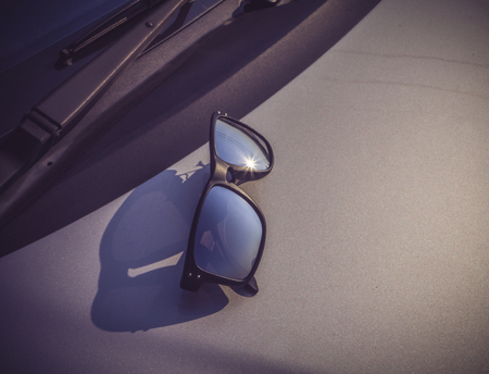 reflective lightsun a sunglasses on carの写真素材