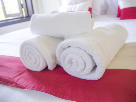 White towel on bed decoration in bedroom interiorの写真素材