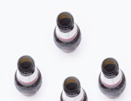 Top view four beer bottle  on white backgroundの写真素材