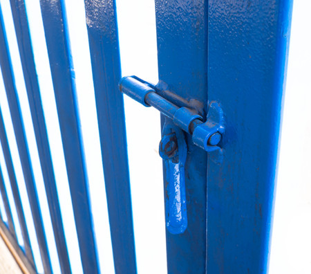 Opening gate.  Old blue steel fenceの写真素材
