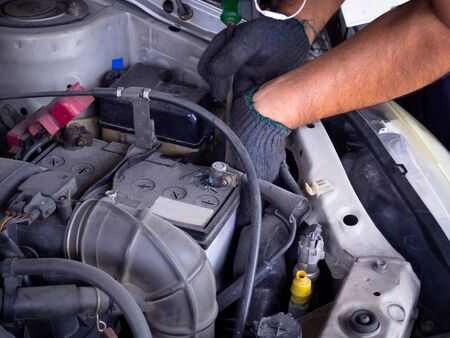 Hand mechanic repairing an old car.
