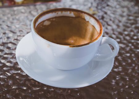 Close up white cup of hot coffee empty and dirty dry coffee stained mark