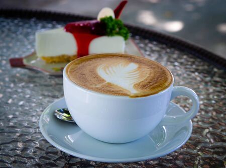 Coffee cup and cake on the glass tableの写真素材