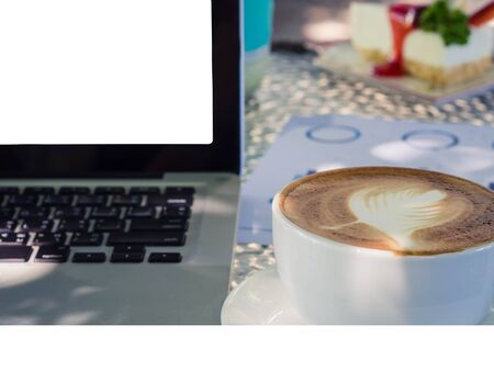 Blank white laptop screen display on the table with a cup of coffeeの写真素材