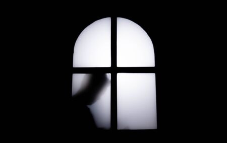 The silhouette of a human in front of a door at night.Scary scene Halloween concept of blurred silhouetteの写真素材