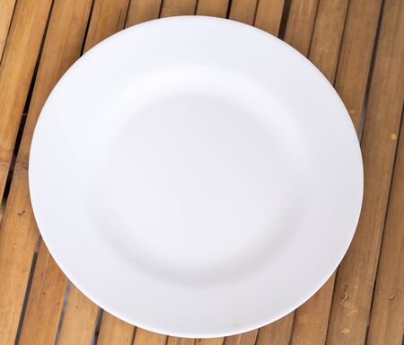 white the dish on a bamboo tableの写真素材