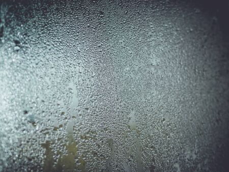 Water droplets condensation background of dew on glass, humidity and foggy blank. Inside open the air conditionerの写真素材