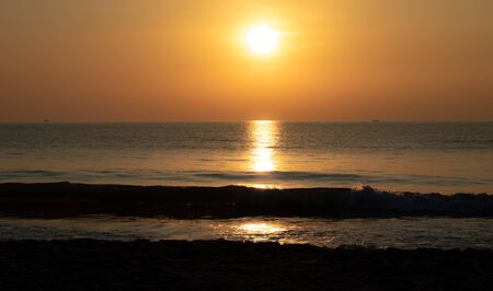 Beautiful sunset landscape at black sea and orange skyの写真素材