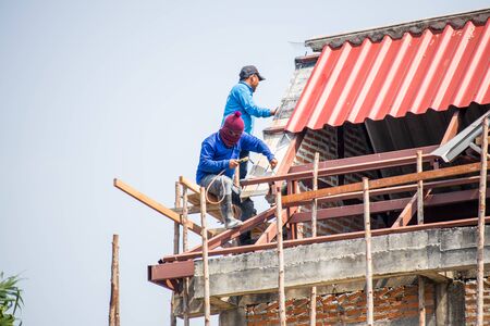 the builders create roof of a private house on a Sunny dayの写真素材