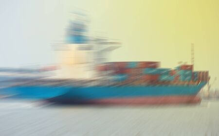commercial container ship on river ,Logistic and navigation concept. A freight boat at the blur shore backgroundの写真素材
