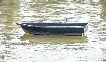 Plastic boat floating in the riverの写真素材