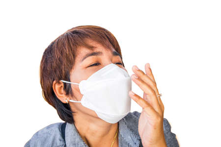 Asian female with protective face mask,She has sneezing on white backgroundの写真素材