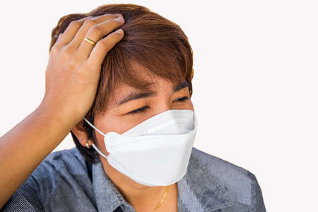 Asian female with protective face mask and She hand takes alcohol disinfectant spray on her hands it is a protective equipment during a virus outbreak on white backgroundの写真素材