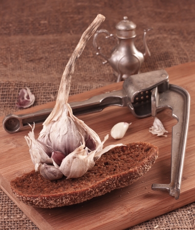 Fresh Garlic and bread on a cutting boardの写真素材