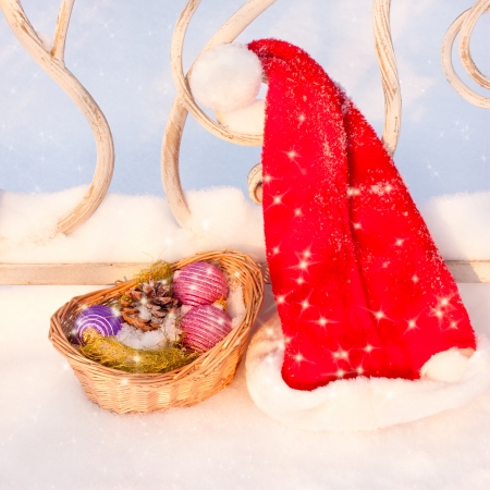 Santa Hat with Christmas basket on snowの写真素材