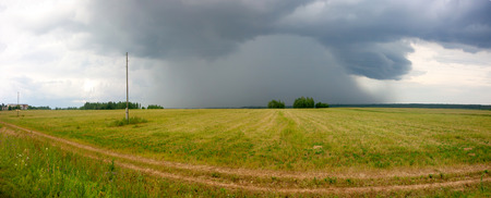 Storm cloud over the field  .Summer landscapeの写真素材