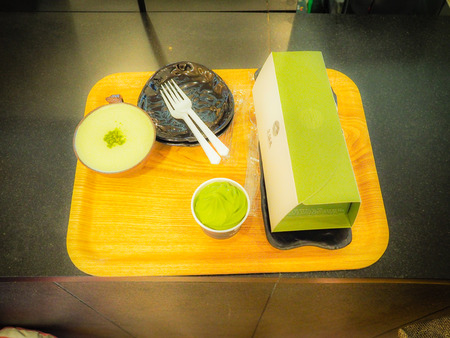 Set of green tea cake, green tea ice cream and hot latte green tea coffee from Osulloc tea museum, the famous green tea shop in Jeju island, South Korea.の写真素材