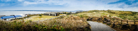 Beautiful landscape view of Seopjikoji, located at the end of the eastern shore of Jeju Island. "Seopji" is the old name for the area, and "Koji" is Jeju dialect meaning a sudden bump on land.の写真素材