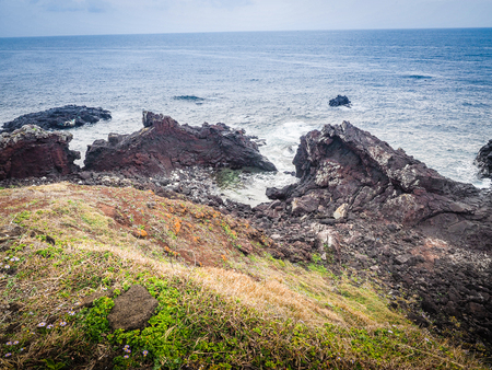 Beautiful landscape view of eopjikoji, located at the end of the eastern shore of Jeju Island. "Seopji" is the old name for the area, and "Koji" is Jeju dialect meaning a sudden bump on land.の写真素材