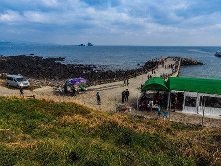 The tourist visited Seongaksan coast, the famous coastal drive with breathtaking scenic views in Jeju islandのeditorial素材