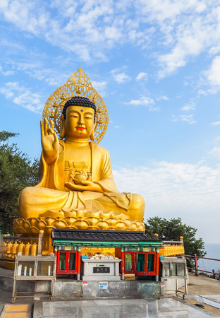 Gold Giant Buddha, Main Buddha Statue at Sanbanggulsa Temple, Sanbanggulsa is in Jeju-Do, Jeju Island in South Koreaの写真素材