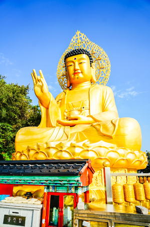 Gold Giant Buddha, Main Buddha Statue at Sanbanggulsa Temple, Sanbanggulsa is in Jeju-Do, Jeju Island in South Koreaの写真素材