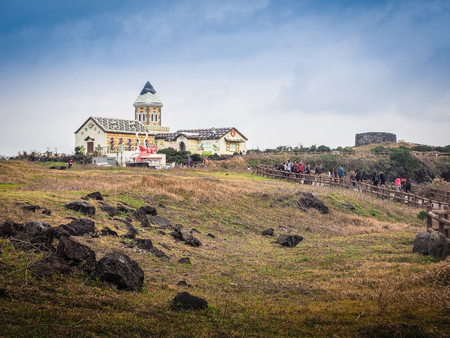 Jeju Island, Korea - November 13, 2016 : The tourist visited the Beautiful Catholic Church at Seopjikoji, located at the end of the eastern shore of Jeju Island. "Seopji" is the old name for the area, and "Koji" is Jeju dialect meaning a sudden bump on laのeditorial素材