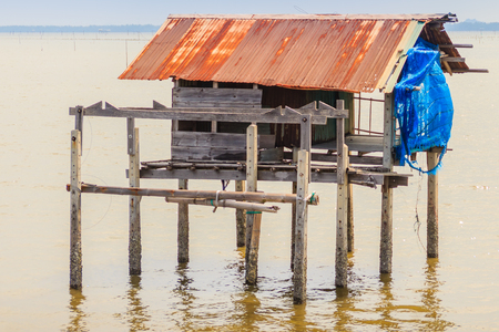 Hut in the sea that used for the owner to stay and guard his cockle farm in Samut Songkram, Thailandの写真素材