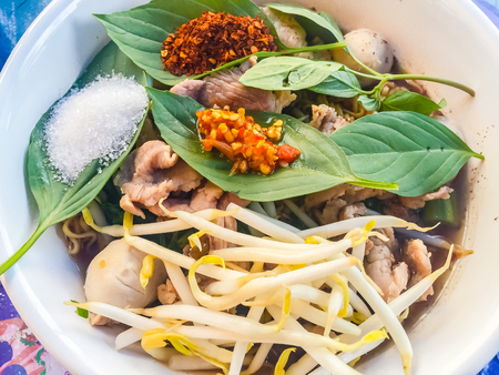 Popular street food in Thailand, Spicy pork noodle that consisted of pork ball, pork meat, basil or...