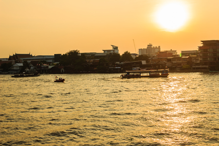 View opposite of Tha Maharaj boat pier in the evening on Chao Phaya river nearby the Grand Palaceの写真素材