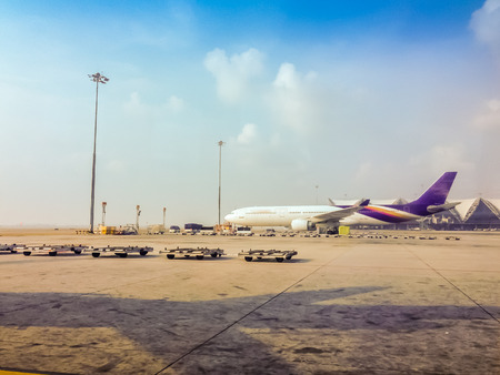 Bangkok, Thailand - April 28, 2015: The airplane is parking in the field for passengers to boarding to the airplane before departure in the morning flight at Suvarnabhumi International Airportのeditorial素材