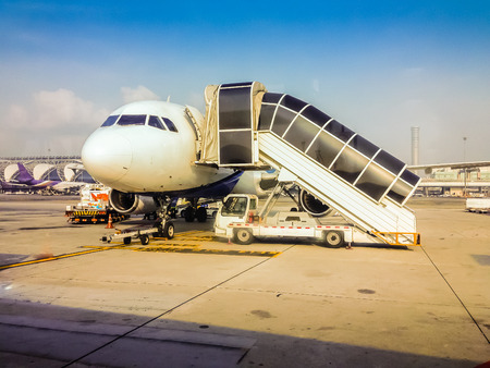 Bangkok, Thailand - April 28, 2015: The airplane is parking in the field for passengers to boarding to the airplane before departure in the morning flight at Suvarnabhumi International Airportのeditorial素材