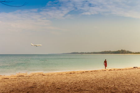 Unidentified tourists and the beautiful seascape view of Naiyang beach while the airplane landing at Phuket international airport, Phuket Province, Thailand.の写真素材