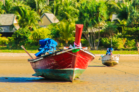 Fishing boats parking on the beach with blue sky background in the cloudy day.の写真素材