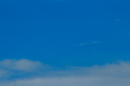Clear blue sky with white clouds. Cloudless sky. Blue sky with a cloud obscured the view daytime desolate empty air clean.の写真素材