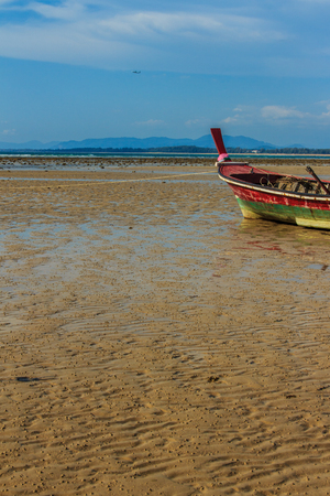Fishing boats parking on the beach with blue sky background in the cloudy day.の写真素材