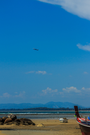 Fishing boats parking on the beach with blue sky background in the cloudy day.の写真素材