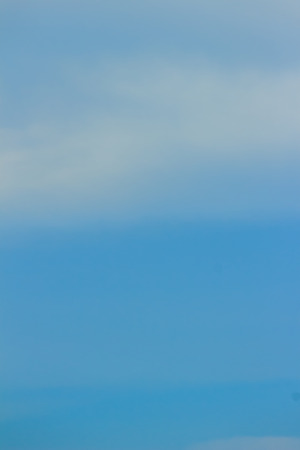 Clear blue sky with white clouds. Cloudless sky. Blue sky with a cloud obscured the view daytime desolate empty air clean.の写真素材