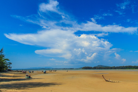 Old wreck fishing boat buried in the sand with blue sky on cloudy day backgroundの写真素材