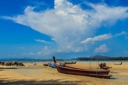 Fishing boats parking on the beach with blue sky background in the cloudy day.の写真素材