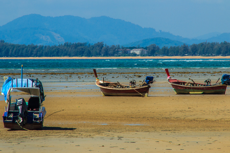 Fishing boats parking on the beach with blue sky background in the cloudy day.の写真素材