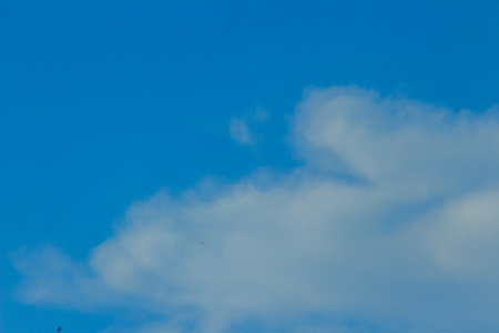 Clear blue sky with white clouds. Cloudless sky. Blue sky with a cloud obscured the view daytime desolate empty air clean.の写真素材