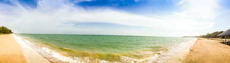 Beautiful 180 degree panorama view of hotel on the beach with white sand and blue sky in background at Phayun Beach, Ban Chang, Rayong, Thailand.の写真素材