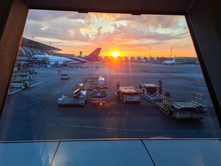 Bangkok, Thailand - November 20, 2015: Beautiful sunrise at Suvarnabhumi Airport after the tourist checked-in for morning flights at approximately 0630 hours.のeditorial素材