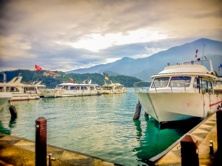 Beautiful Landscape of Sun Moon Lake in the morning with blue mountain background at Sun Moon Lake in Yuchi Township, Nantou County, Taiwanのeditorial素材