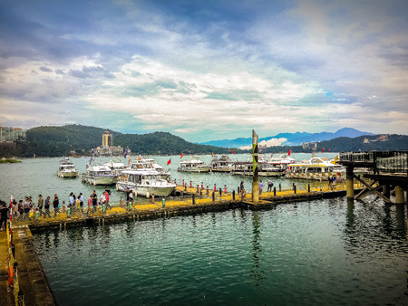 Nantou, Taiwan - November 21, 2015: Tourist likes to visit the beautiful attractions around the sun moon lake by boat cruise from Shuishe Pier to Ita Thao Pier, and then to Xuanguang Temple Pierのeditorial素材