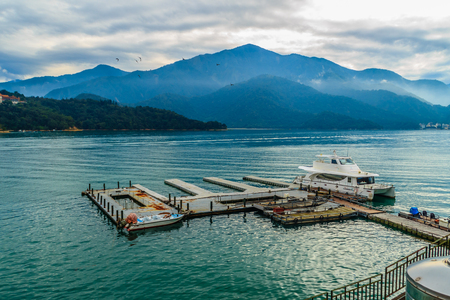 Beautiful Landscape of Sun Moon Lake in the morning with blue mountain background at Nantou, Taiwanの写真素材