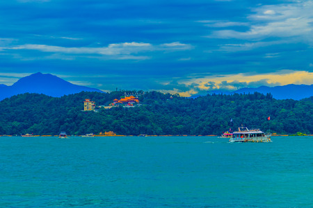 Beautiful Landscape of Sun Moon Lake in the morning with blue mountain background at Sun Moon Lake in Yuchi Township, Nantou County, Taiwanの写真素材